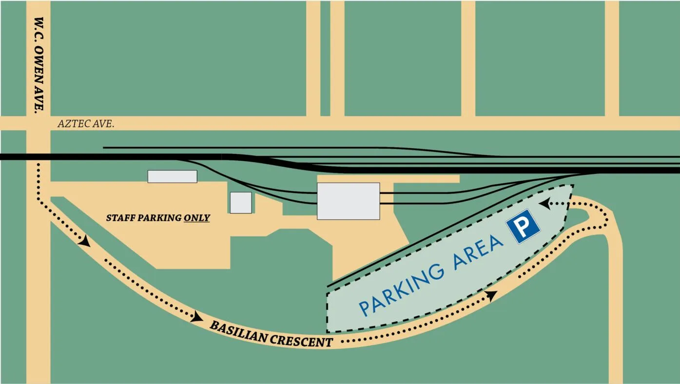Map showing a parking area next to train tracks and buildings.