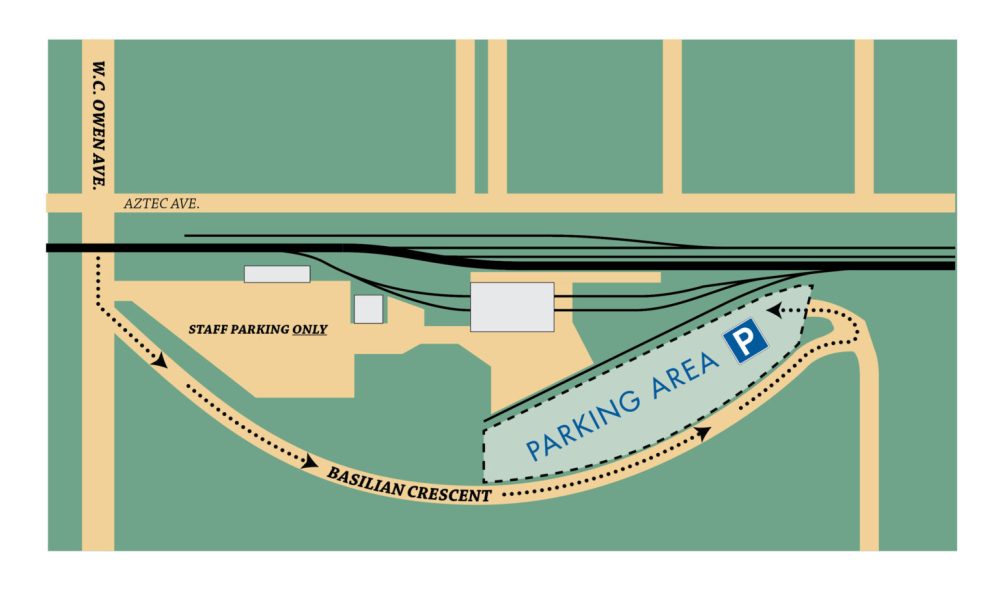 Map showing a parking area next to train tracks and buildings.